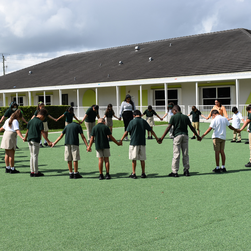 Teacher guiding young children during a hands-on lesson